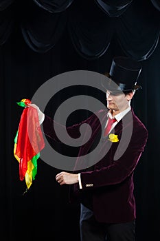 Magician, Juggler man, Funny person, Black magic, Illusion focus with colored cloth with cloths