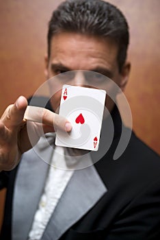 Magician performing with card