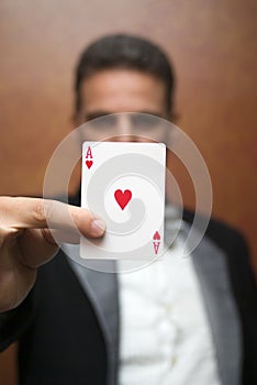 Magician performing with card