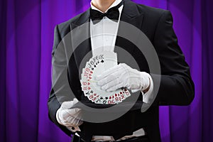 Magician Putting Playing Cards In Hat