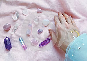 magician's hand holds, selects the necessary crystals and minerals for a session of harmonization, crystal therapy, healing