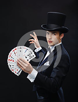 Magician showing trick with playing cards