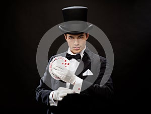 Magician showing trick with playing cards