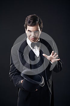 Magician showing tricks with top hat isolated