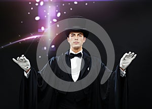 Magician in top hat with magic wand showing trick