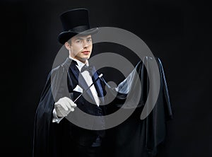 Magician in top hat with magic wand showing trick