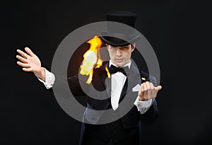 Magician in top hat showing trick with fire