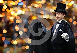 Magician in top hat showing trick with magic wand