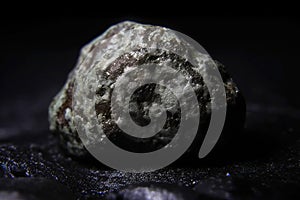 Magnesia fossil mineral stone. Geological crystalline fossil. Dark background close-up. photo