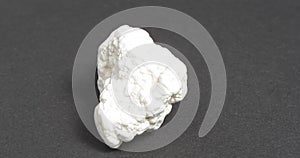 Magnesite on a dark background. It is used in industry, lithotherapy, jewelry.