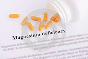 Magnesium deficiency diagnosis on paper with pills spilling out