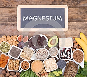 Magnesium food sources, top view on wooden background