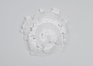Magnesium nitrate powder on light grey background.