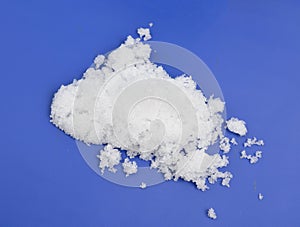 Magnesium nitrate powder on light grey background.