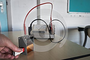 Magnet is pushed into a copper coil, inducing an electrical current through induction