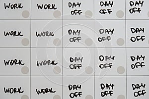 Magnetic board writing 4 day work week calendar with three weekend days off four day working week concept. Modern