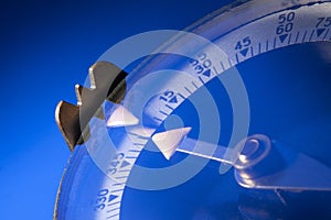 Magnetic compass on blue background. Macro photo