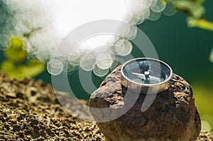 The magnetic compass lies on a stone at the edge of the reservoir .