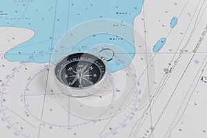 Magnetic compass on a nautical navigational map