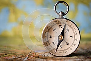 Magnetic compass on a world map