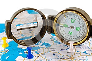 Magnetic compass on a world map conceptual of global travel , tourism and exploration.