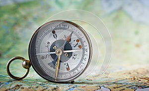 Magnetic compass on world map.Travel, geography, navigation, tou