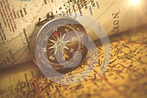 Magnetic compass on a world travel map. Navigation and exploration concept, selective focus photo