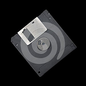 Magnetic floppy disc on a black background.