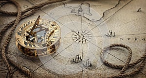 Magnetic old compass  and rope on vintage world map. Travel, geography, navigation, tourism and exploration concept wide