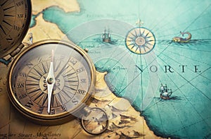 Magnetic old compass on world map.Travel, geography, navigation, tourism and exploration concept background. Treasure Island on