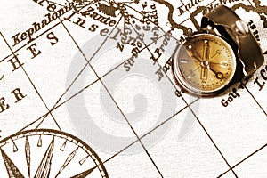 Magnetic old compass on world vintage  map.Travel, geography, navigation, tourism and exploration concept background.Macro shot,