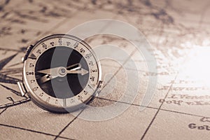 Magnetic old compass on world vintage  map.Travel, geography, navigation, tourism and exploration concept background.Macro shot,