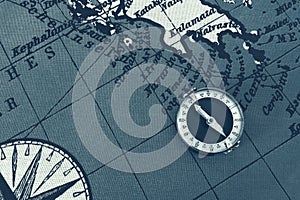 Magnetic old compass on world vintage  map.Travel, geography, navigation, tourism and exploration concept background.Macro shot,