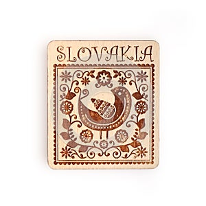 Magnetic souvenir from Slovakia with the image of a traditional ornament isolated on white background. Design element with