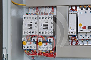 Magnetic starters with thermal relays connected by wires.