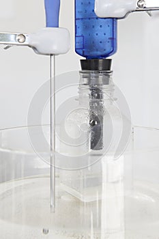 Magnetic stirrer with thermostat sensor detail and bottle