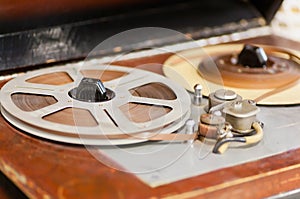 Magnetic tape with the music playing on the vintage reel tape recorder