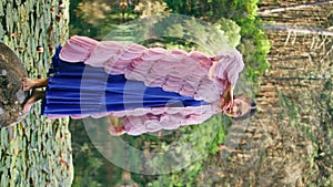 Magnetic woman posing nature pond with water lilies. Model dancing vertically