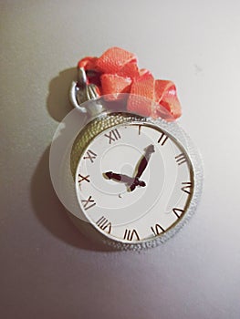 Magnets clock on a grey fridge