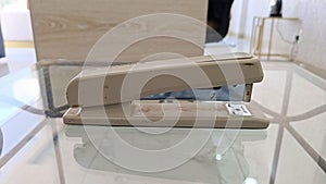 close up of big size stapler on mirror table
