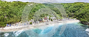 Magnificent aerial panorama of tropical beach at end of mountain valley with coconut palms, boats in blue water in Ocean gulf,