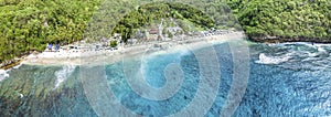Magnificent aerial panorama up down photo of tropical beach at the end of mountain valley with coconut palms, boats in blue water