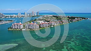 Magnificent aerial view of Fisher Island with its luxurious high-rise residences and mansions overlooking Atlantic ocean