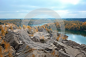 A magnificent autumn view of the turquoise water and mountains on the Romantsevsky rocks in the village of Konduki photo