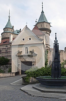 Magnificent castle Bojnice with fountain in the foreground