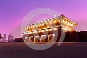 Chinese gate tower of tang dynasty under ultra violet night sky, srgb image