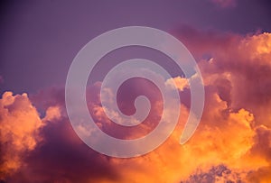 Magnificent colorful clouds in the evening sky. Bright, pink clouds in the sky at sunset. Beautiful evening skyscape. Abstract, pu