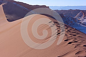 Magnificent dunes surrounded by rock formations at high altitude in Atacama Desert, Chile, South America.