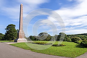 Magnificent McGrigor Obelisk with flower beds in front on a blue sky background, Duthie Park, Aberdeen