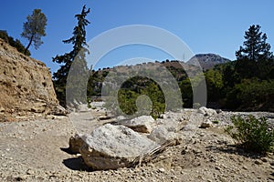 Magnificent mountainous landscape in the vicinity of the parched riverbed of the Loutani river. Kolympia, Rhodes, Greece